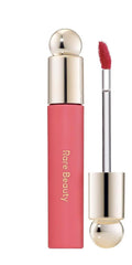 Rare Beauty huile à lèvres teinte Happy, hydratation durable et fini gloss léger.