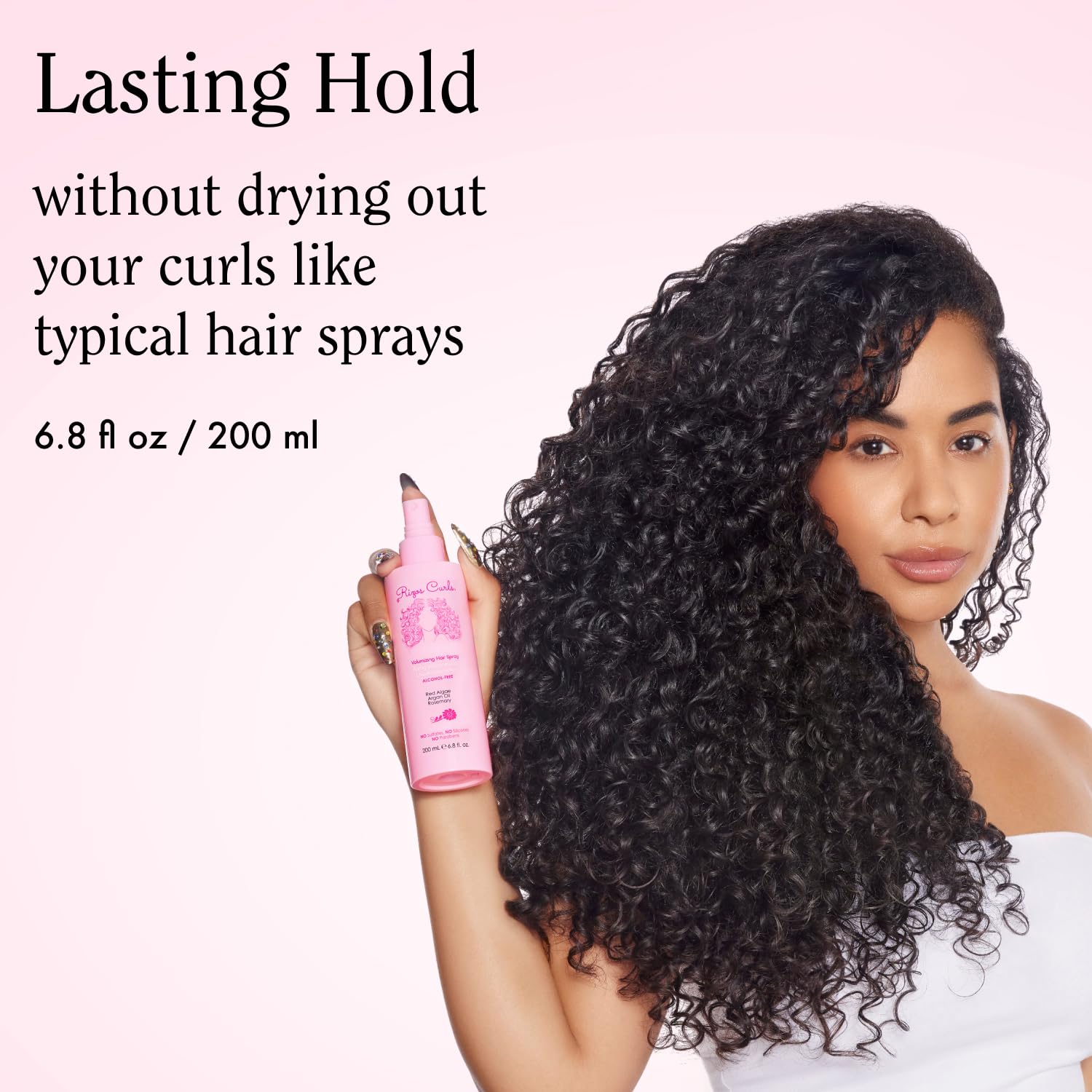 Rizos Curls spray mist dispersing on curly hair for bounce.