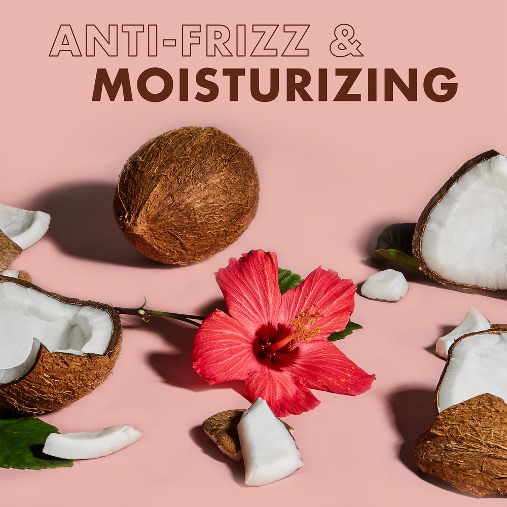 Application sur cheveux humides avec SheaMoisture pour des boucles mieux définies.