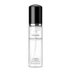 Tan-Luxe Hydra Mousse – flacon clair, hydratation sans transfert pour une peau lumineuse.