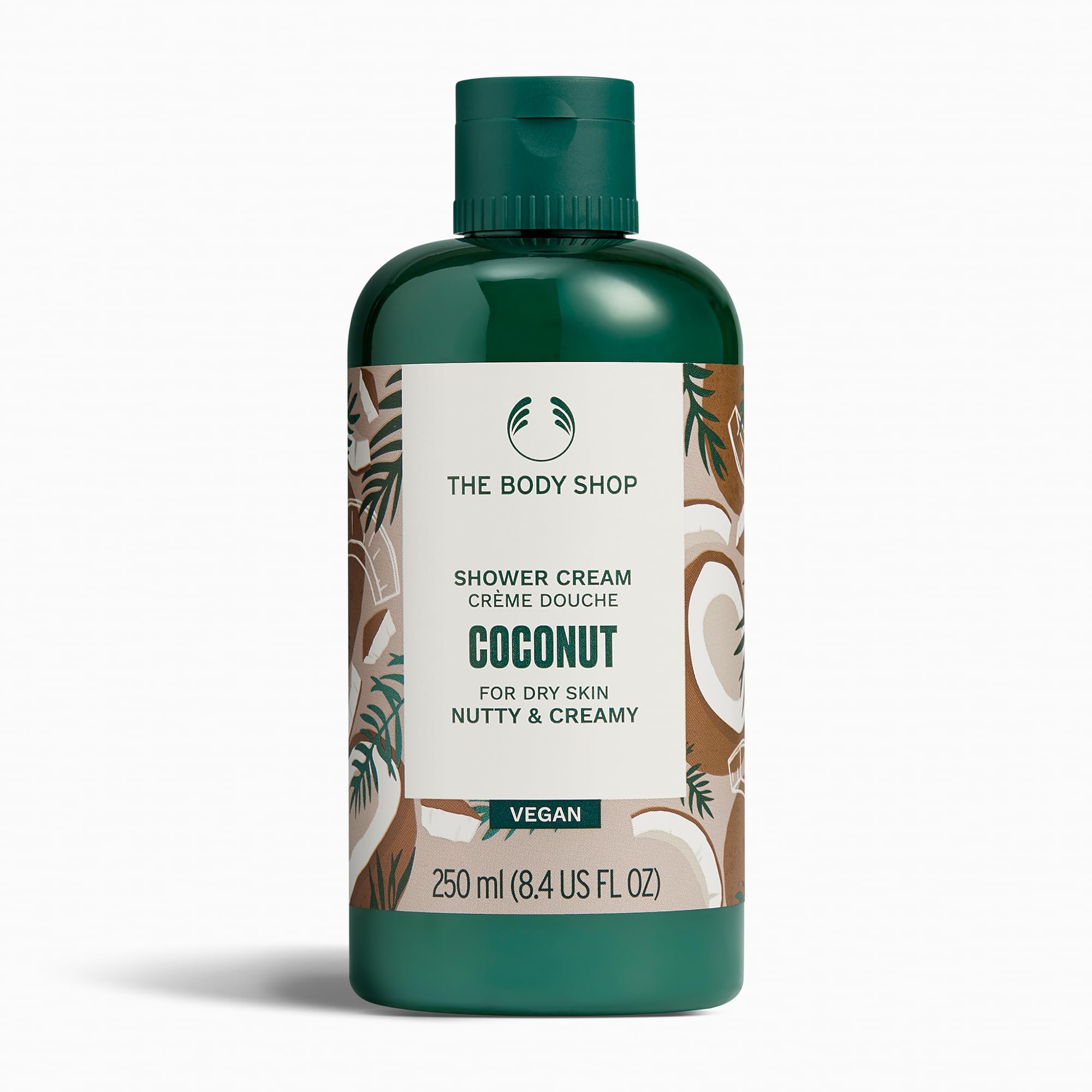 The Body Shop Coconut Shower Cream — bouteille crémeuse avec parfum noix pour peau douce après la douche.