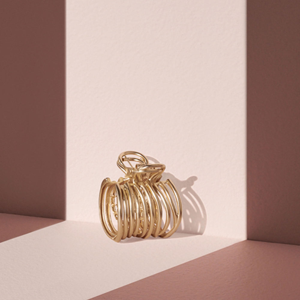 The Hair Edit pince-cheveux doré enveloppant: solution rapide pour un style élégant.
