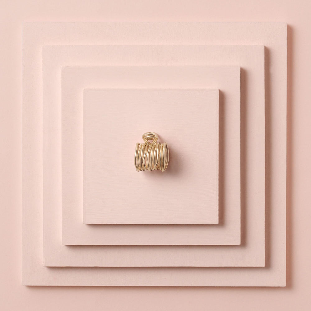 The Hair Edit pinces dore enveloppantes pour queue de cheval, finition sophistiquée.