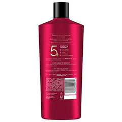 Keratin Smooth Shampoo lather spreading through hair for detangling ease.