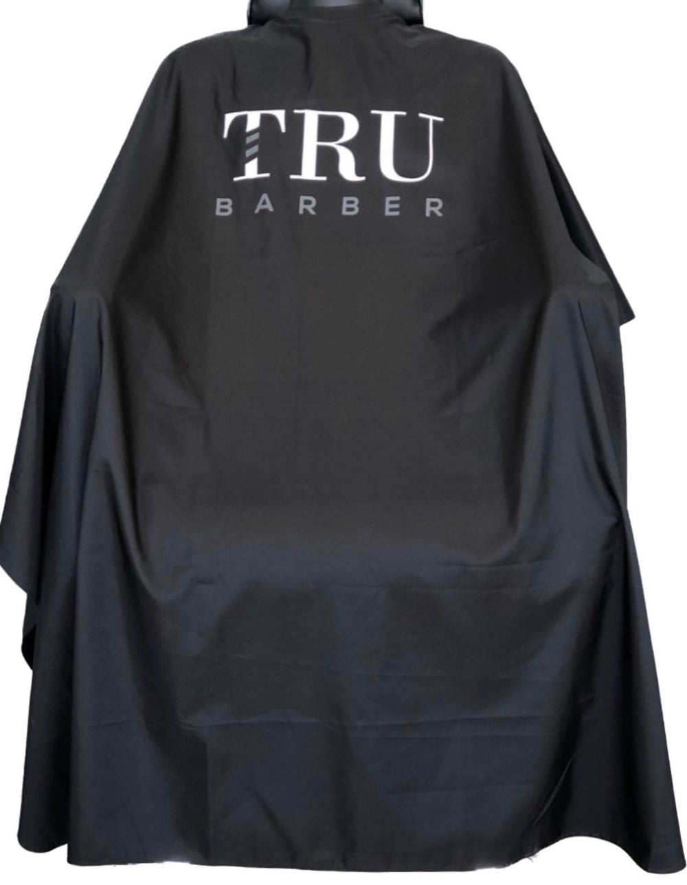 Cape de cou TRU BARBER en silicone pour salon — protège contre éclaboussures et cheveux.