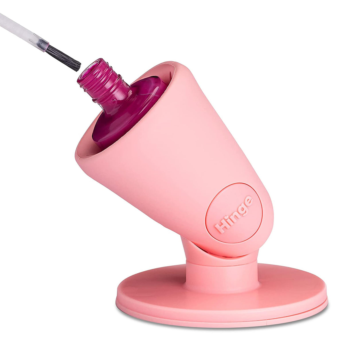 Tweexy Hinge maintient une bouteille de vernis anti-renversement sur une surface.
