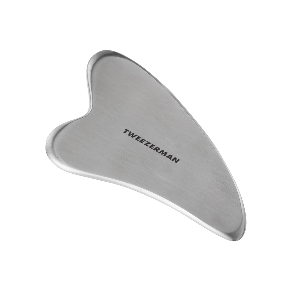 Tweezerman Gua Sha en acier inoxydable pour un massage visage apaisant et contours bien définis.