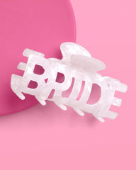 Clip XO Fetti Bride, lettres BRIDE visibles des deux côtés pour un look net.